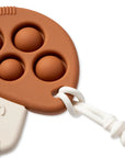 Brown silicone mold with white handle on a white background