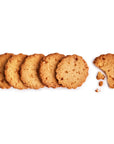 Row of whole cookies with one broken cookie on a white background
