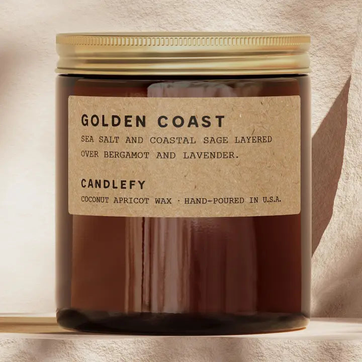 Candle with 'Golden Coast' label on a neutral background