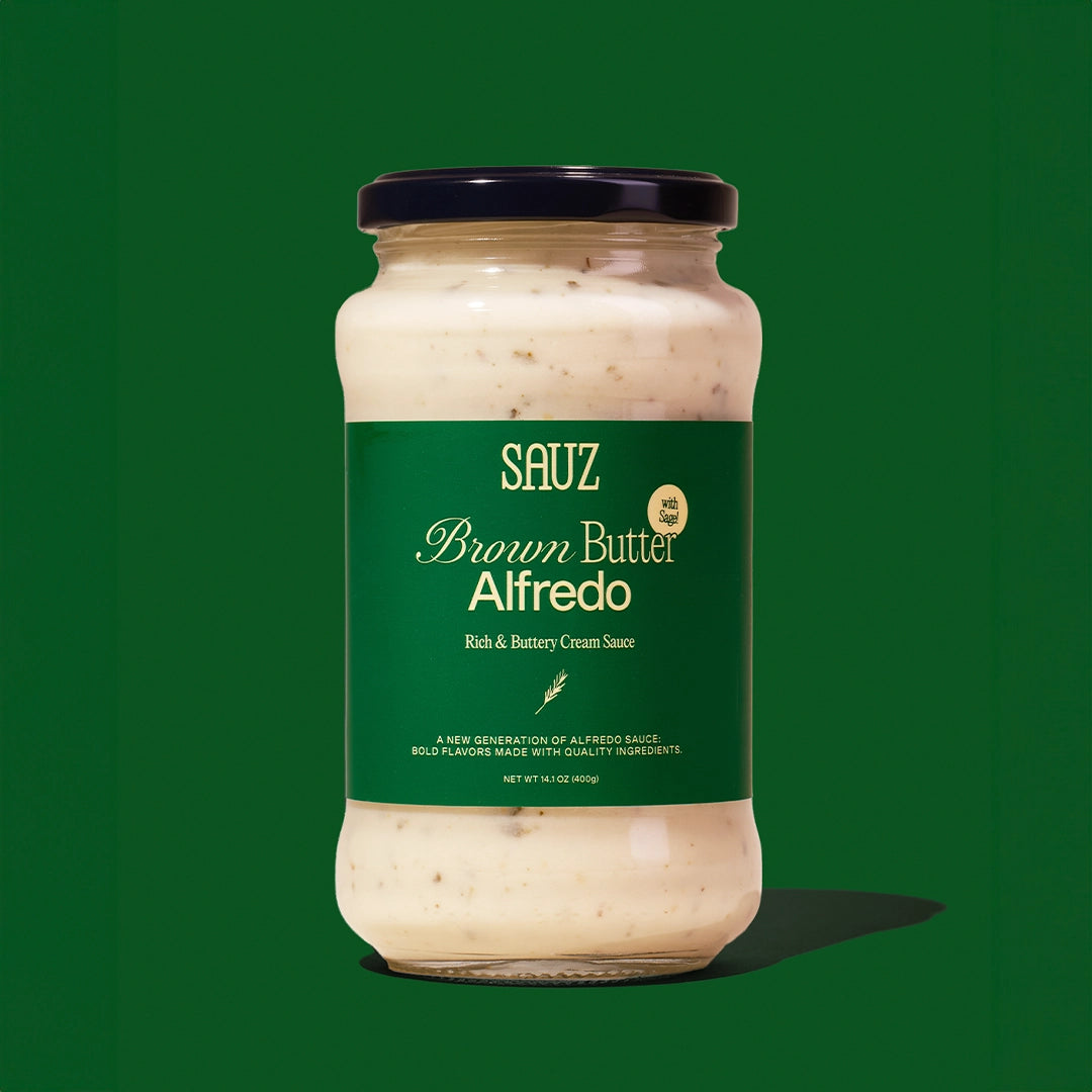 Jar of Sauz Brown Butter Alfredo sauce on a green background