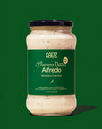 Jar of Sauz Brown Butter Alfredo sauce on a green background