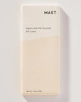 Mast Organic Oat Milk Chocolate bar packaging on a light gray background