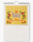 March page of the 2025 Cheese Calendar featuring Manchego cheese from La Mancha, Spain. The illustration includes a sheep surrounded by roses with vibrant yellow and red tones.