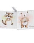 Children's soft book with illustrations of a raccoon and a bear on white pages.
