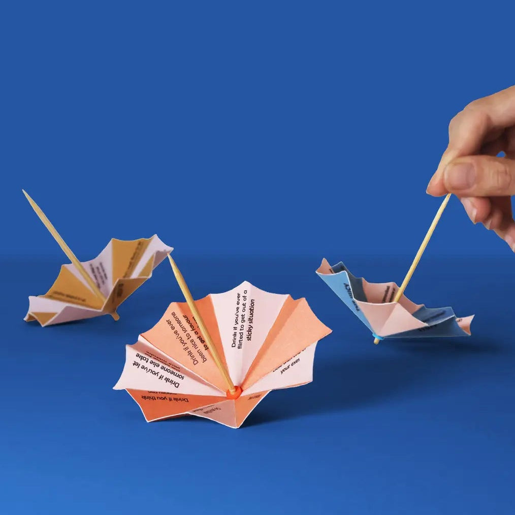 Hand interacting with paper boats on a blue background