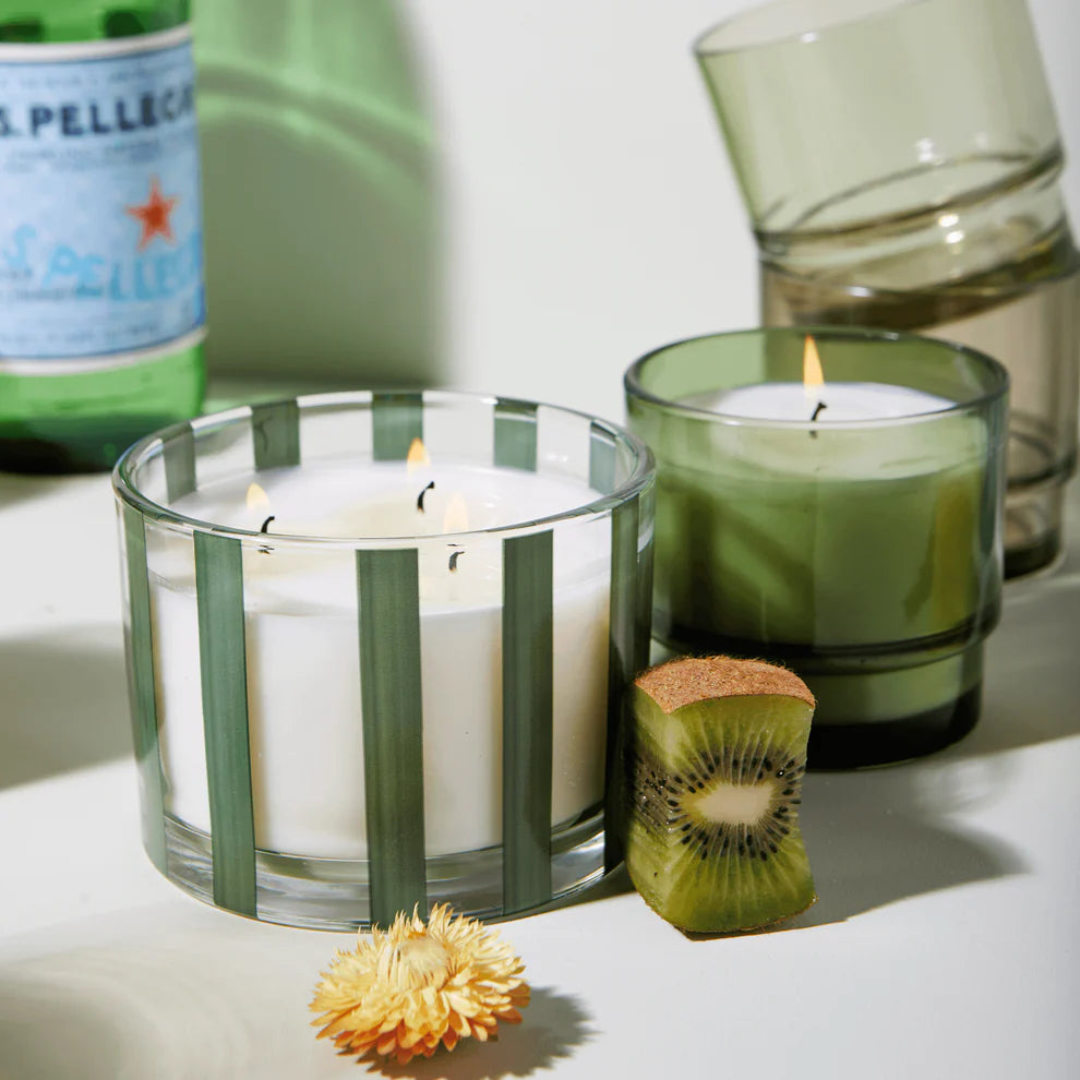Misted Lime Al Fresco 12 oz. Candle surrounded by candle, glasses, sparkling water, kiwi and flower