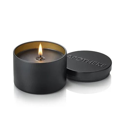 Black candle in a tin with 'Apotheke' branding on a white background