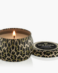 Candle in a decorative container with 'Voluspa' branding on a white background