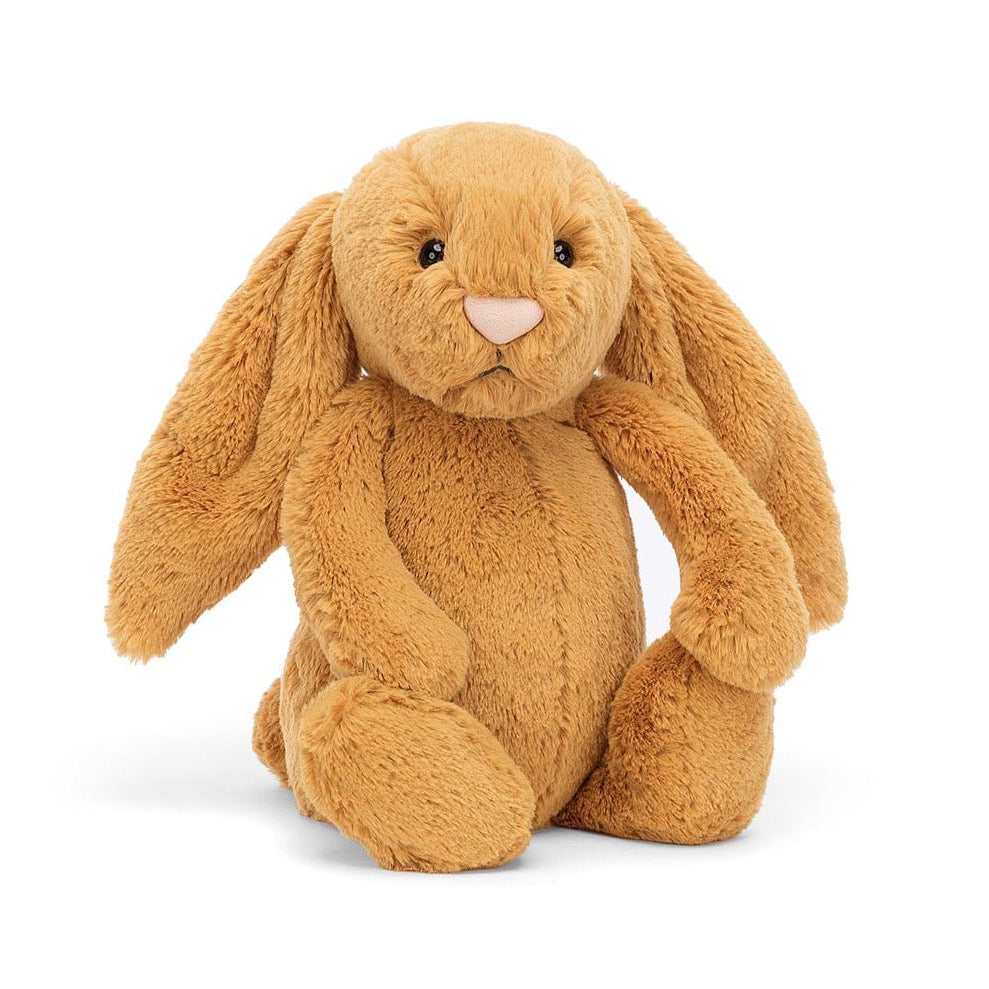 light brown with golden undertones colored bunny stuffed animal with black eyes and  very pale pink nose