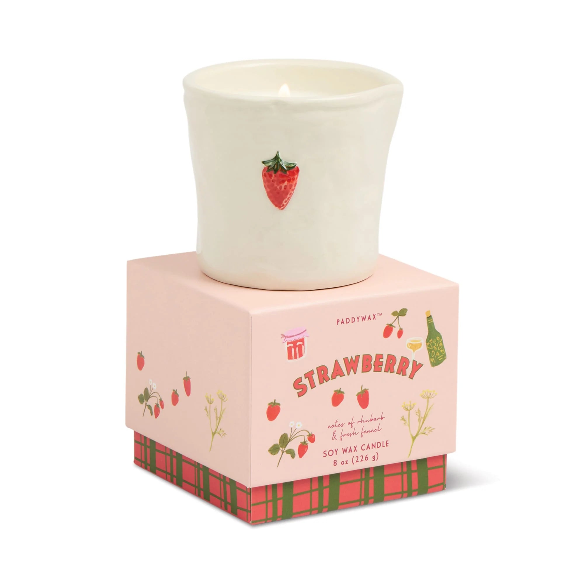 Candle in a decorative box with strawberry design on a white background