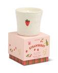 Candle in a decorative box with strawberry design on a white background