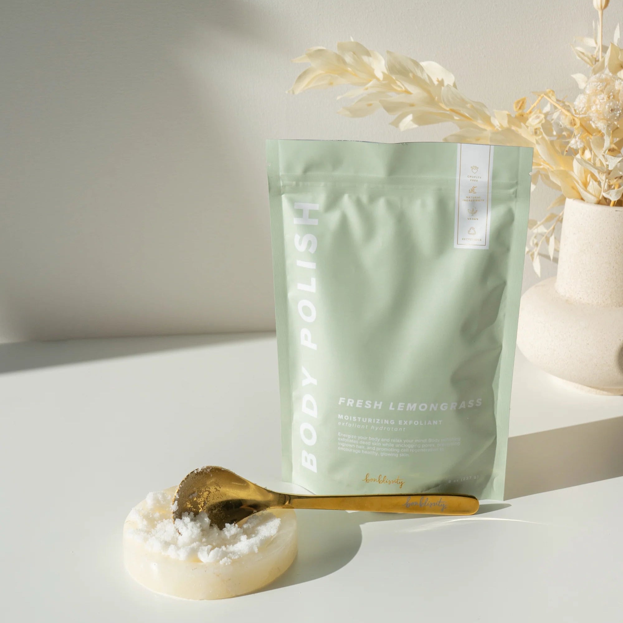 Bodypoint product packaging with a spoonful of product on a white surface.