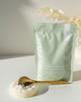 Bodypoint product packaging with a spoonful of product on a white surface.