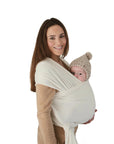 woman holding baby in white baby wrap around her chest