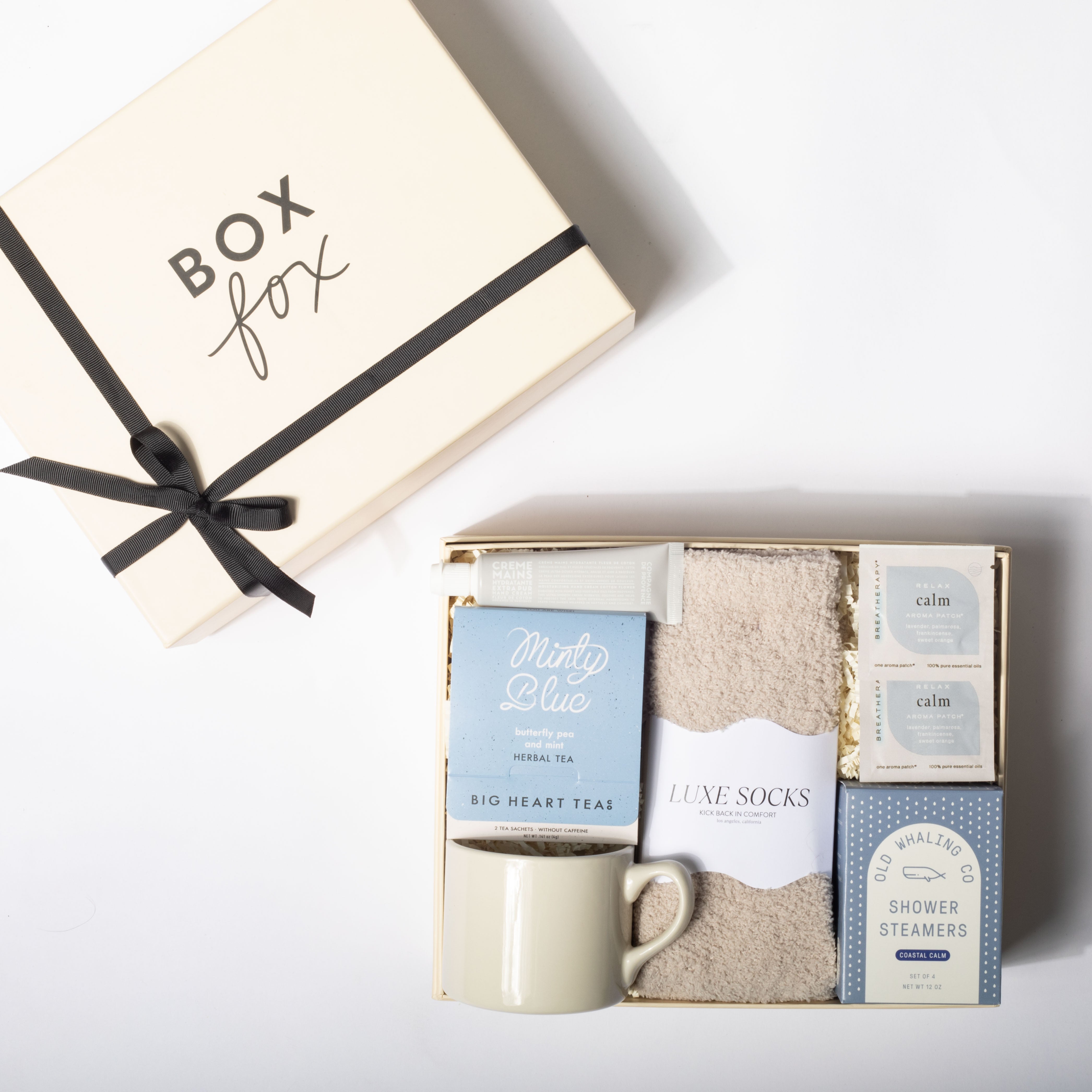 Gift set with tea, socks, and bath items from Box Fox on a white background