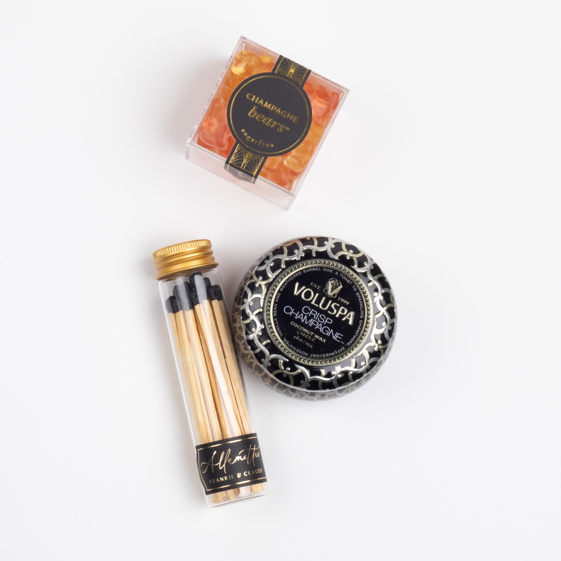 CHAMPAGNE TOAST CURATED BOX ITEMS DISPLAYED: Champagne Bears, Crisp Champagne Mini Tin Candle, and Black Match Jar