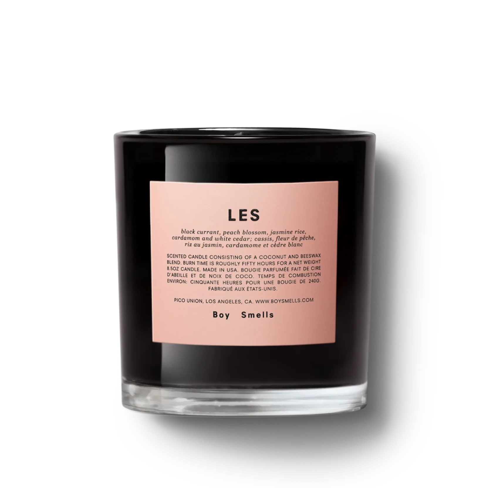 glossy black glass candle with pink label on it. pink label has black text