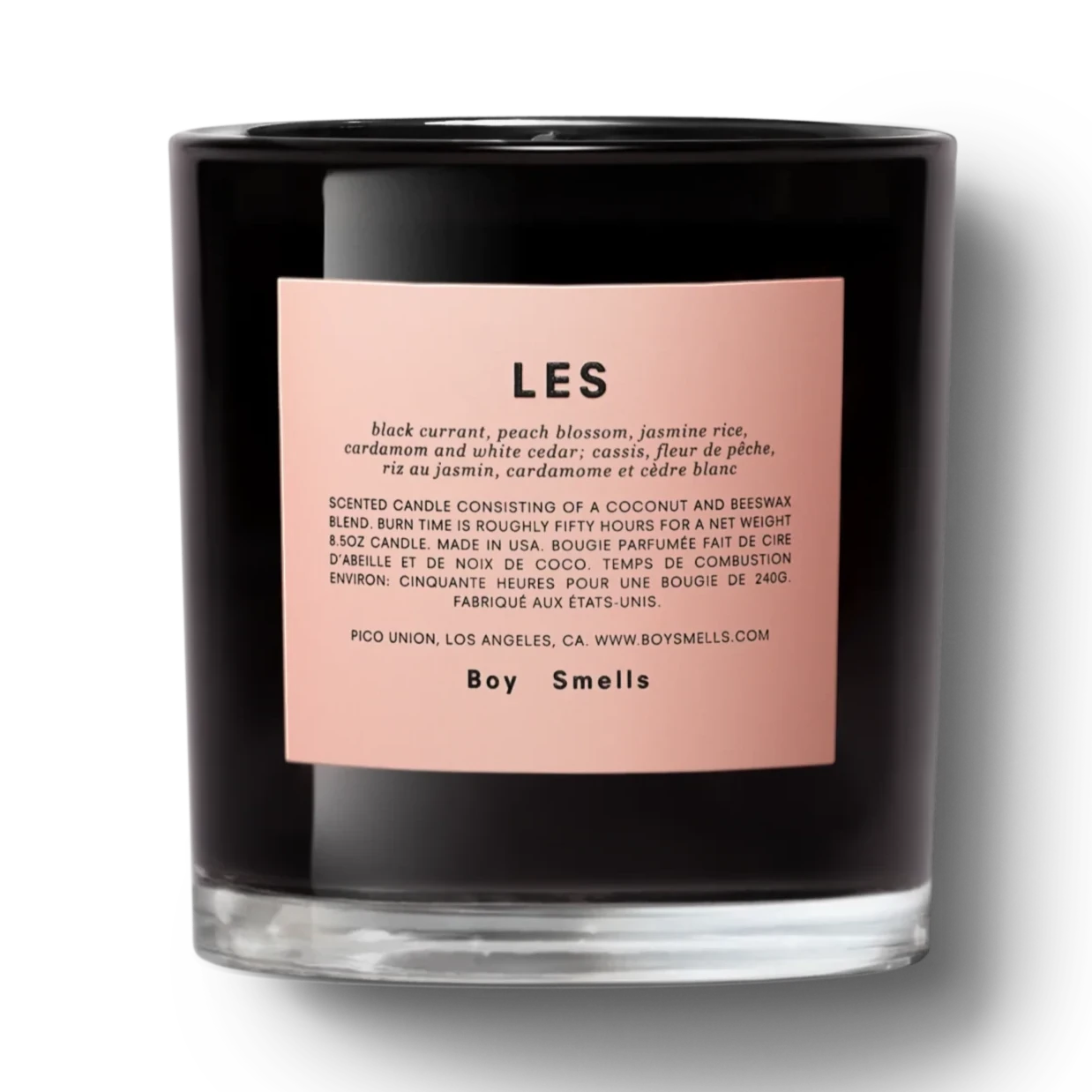 glossy black glass candle with pink label on it. pink label has black text