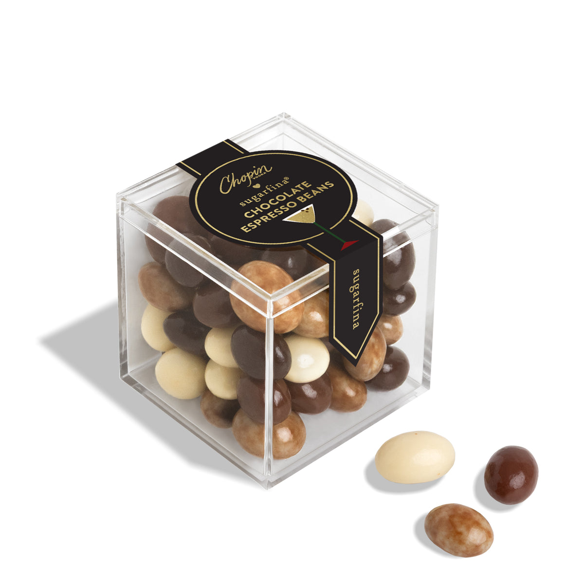 A clear acrylic cube box filled with assorted chocolate-covered beans, with three loose beans placed in front on a white background. The box has a black label reading 'Chopin' and 'Chocolate Bean Mix'.