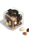 A clear acrylic cube box filled with assorted chocolate-covered beans, with three loose beans placed in front on a white background. The box has a black label reading 'Chopin' and 'Chocolate Bean Mix'.