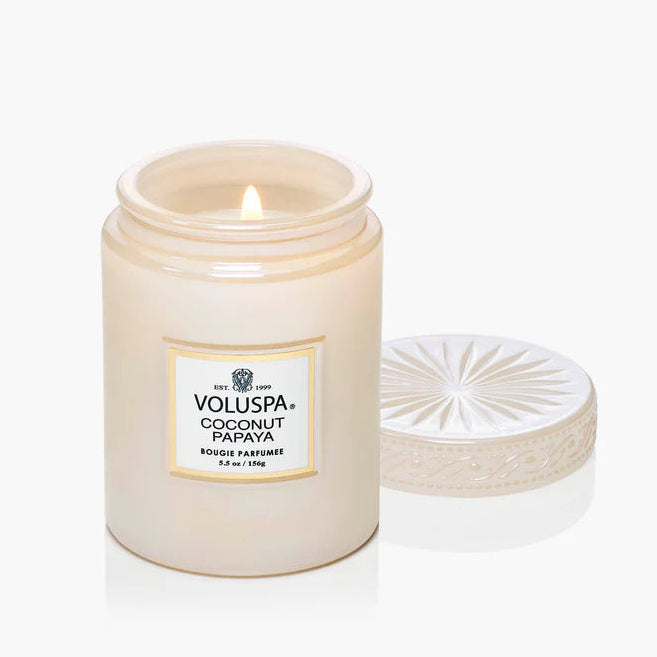 Voluspa Coconut Papaya candle with lid on a white background