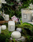 Mokara candle collection in nature scene