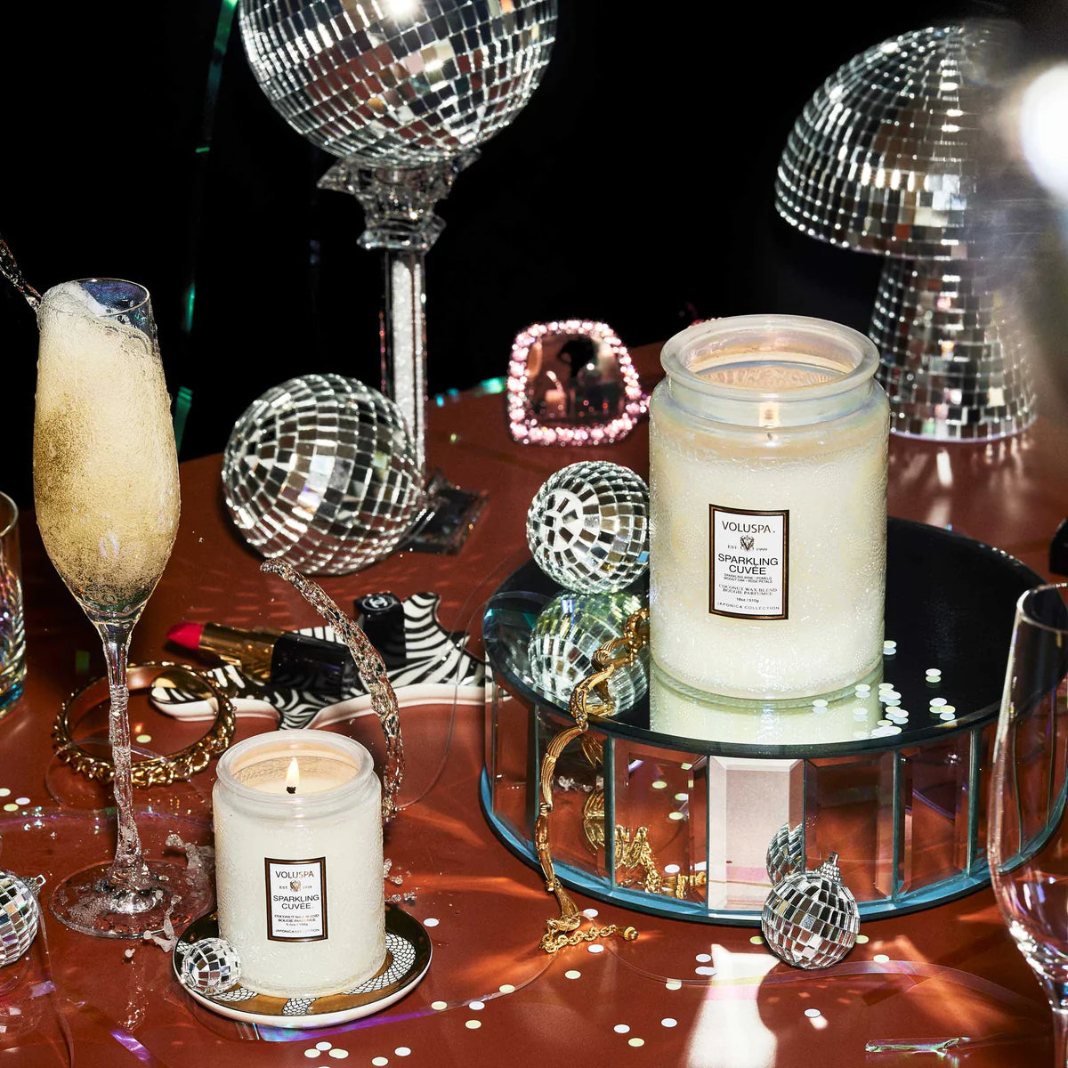 Sparkling Cuvée Medium Glass Jar Candle next to champagne coupes and sparky things
