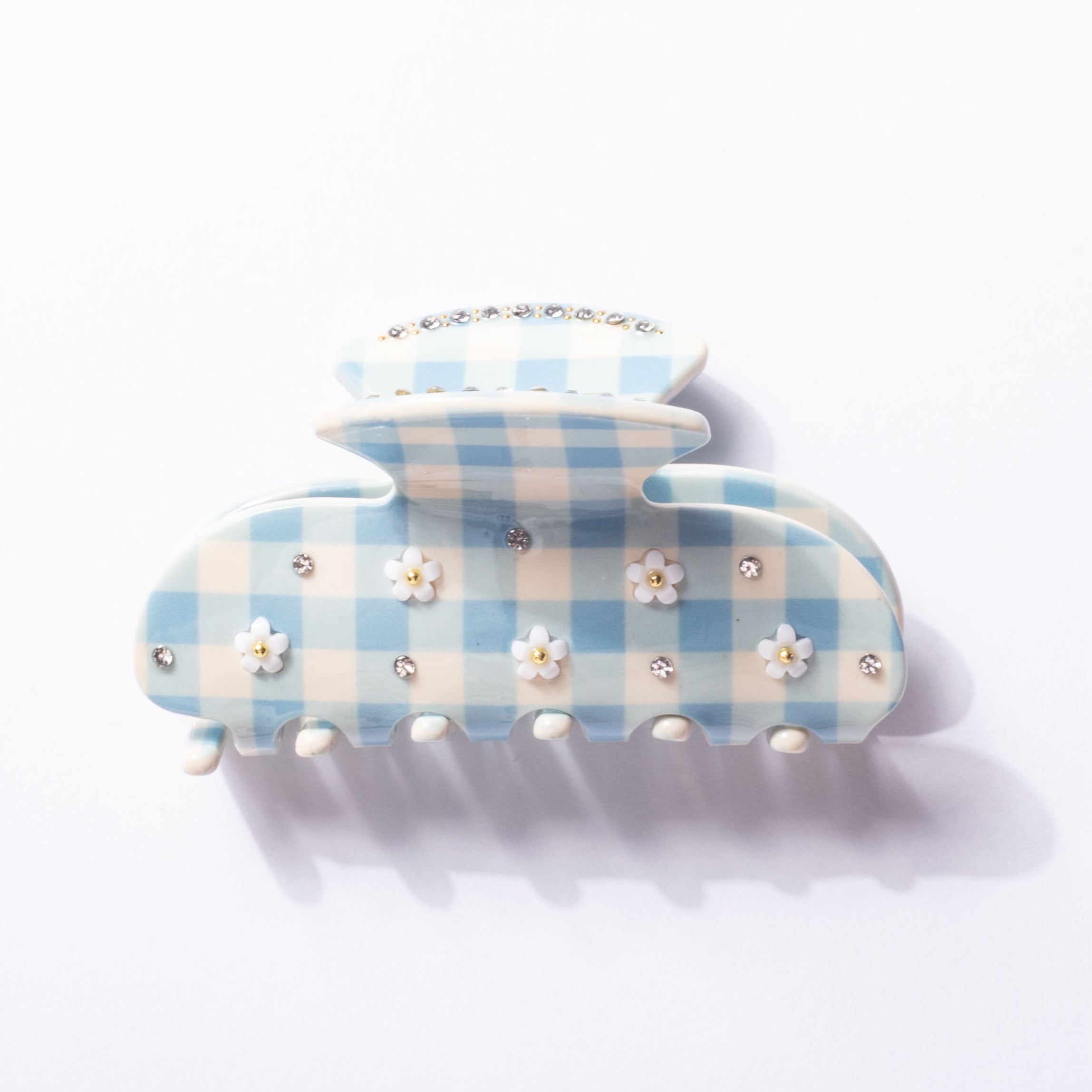 Blue and white checkered hair clip with floral and rhinestone details on a white background