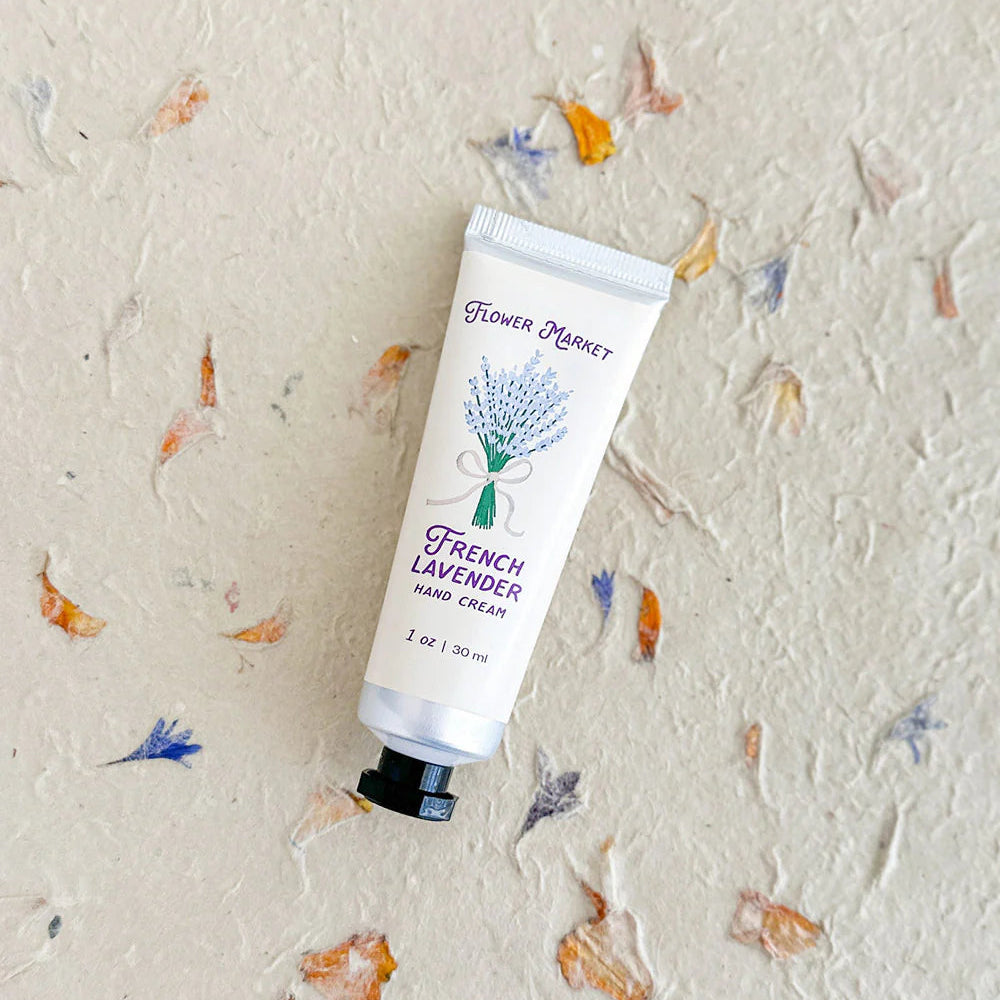 Hand cream tube labeled 'French Lavender' on a textured background with floral patterns.