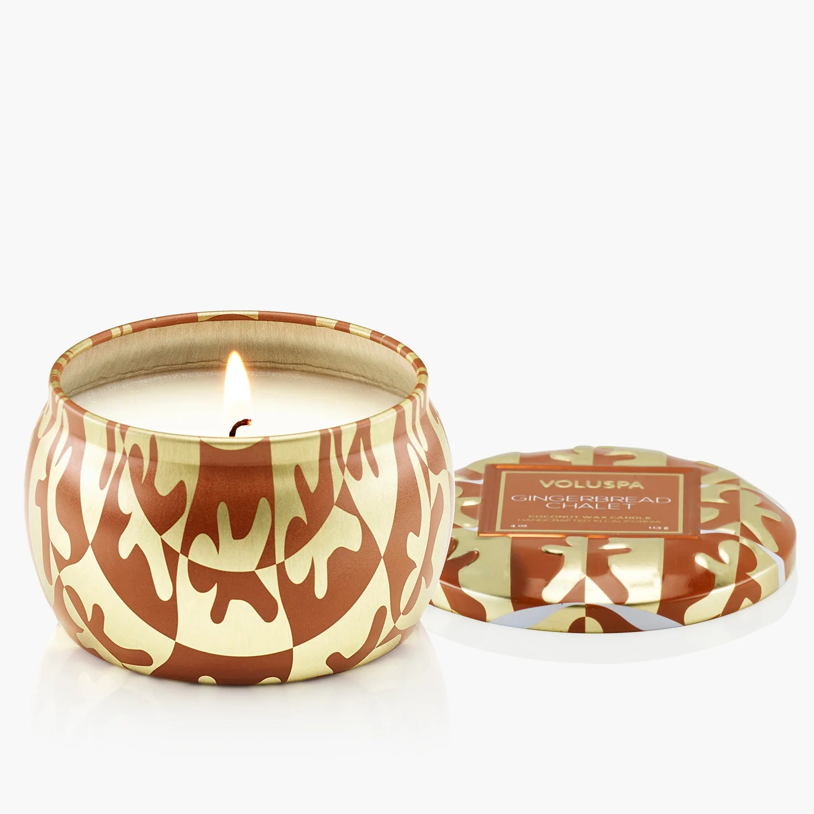 Candle in a decorative container with a pattern on a white background