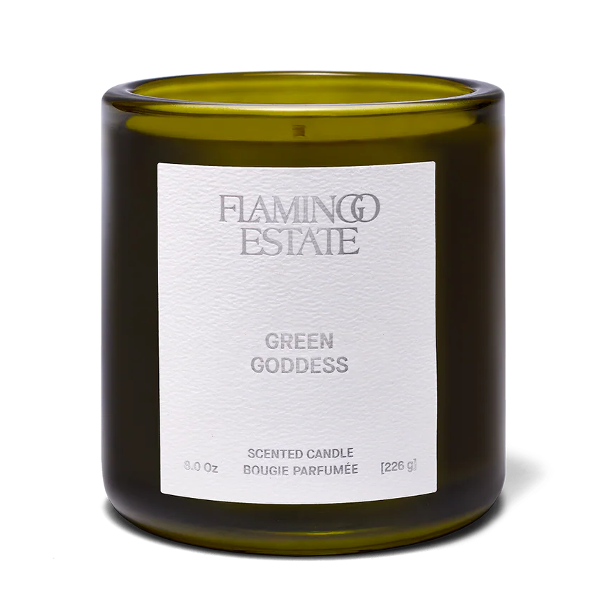 Green candle with a white label on a white background