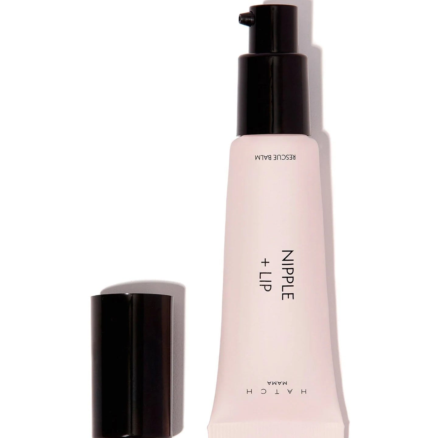 Pink cosmetic tube with black cap on a white background
