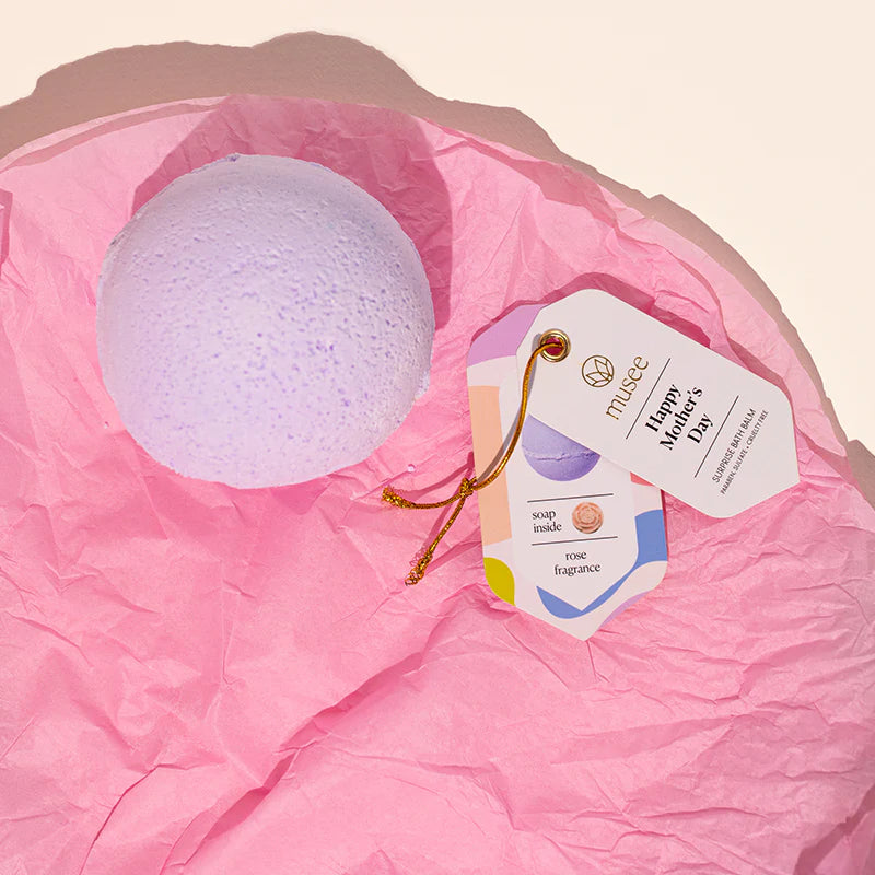 Bath bomb with a 'Happy Mother's Day' tag on pink tissue paper