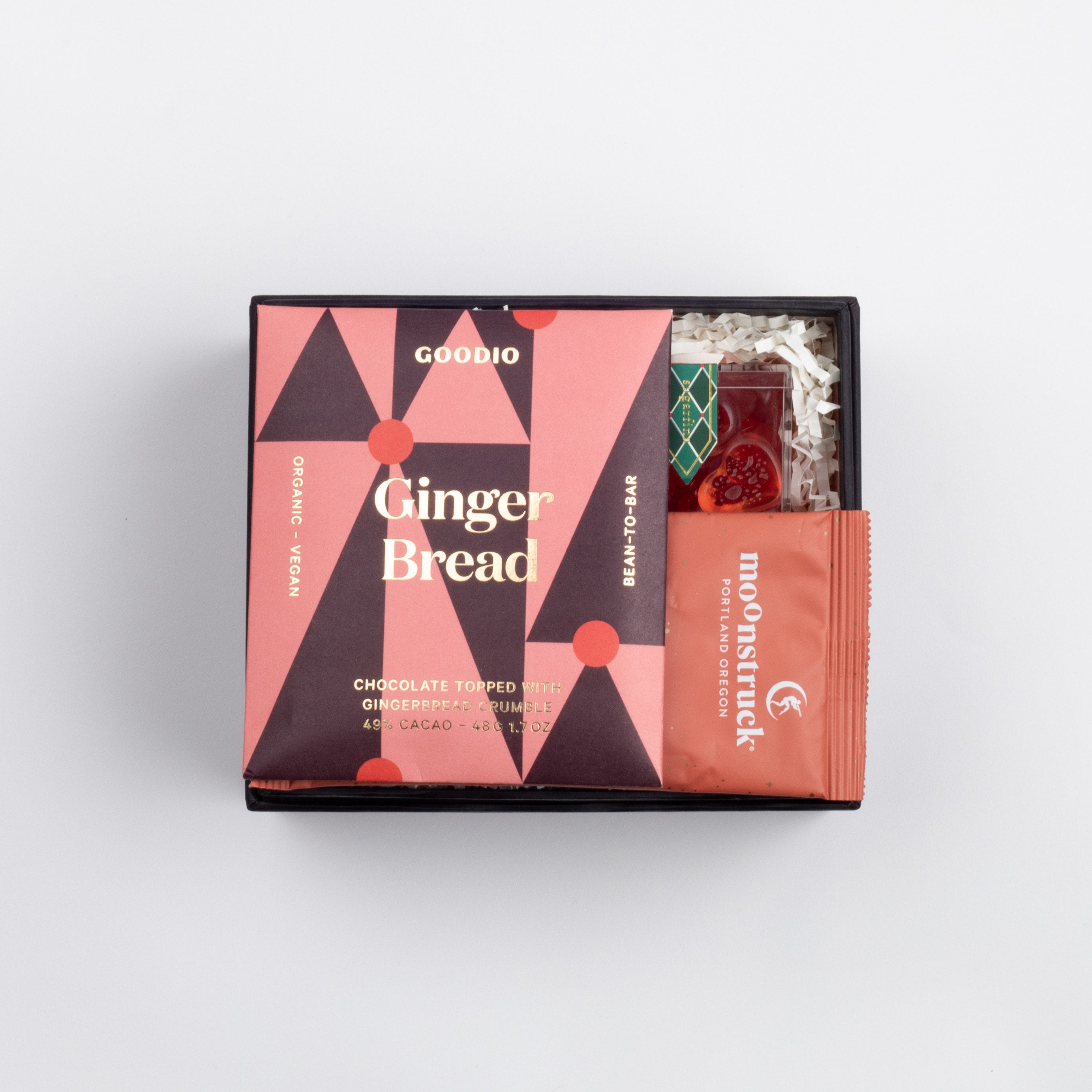 BLACK BOXFOX BOX OPEN WITH ITEMS: Holiday Hearts, Gingerbread Chocolate Bar, Cinnamon Milk Chocolate Hot Cocoa Packet