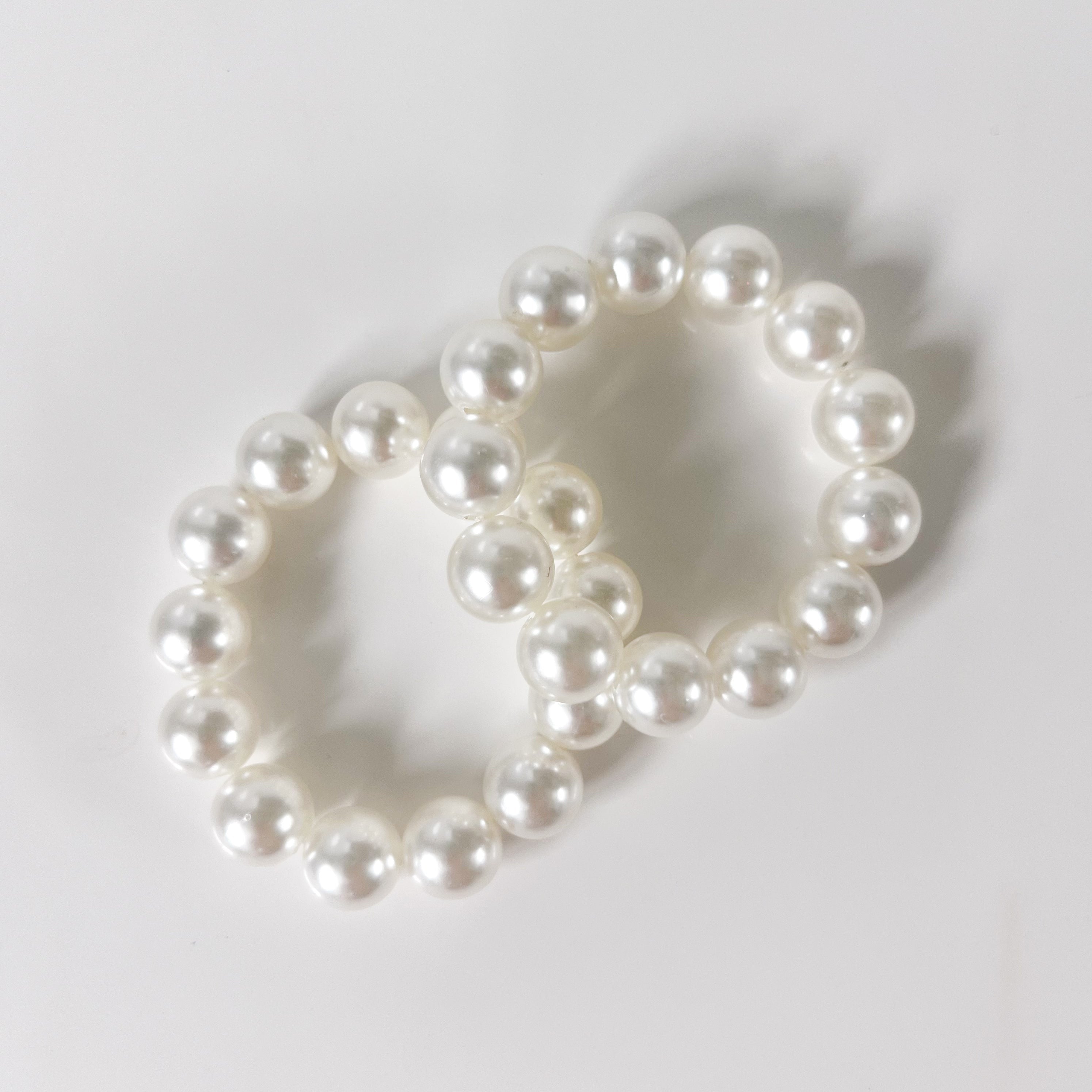 two elastics with pearls threaded through them