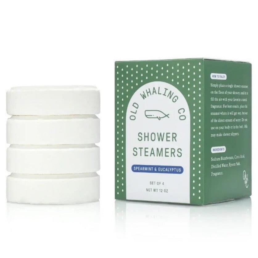 white round shower steamers next to green and white polka dotted box