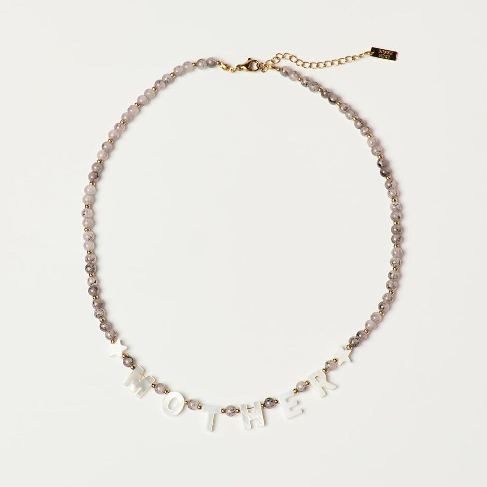 Necklace with small stones on a light gray background