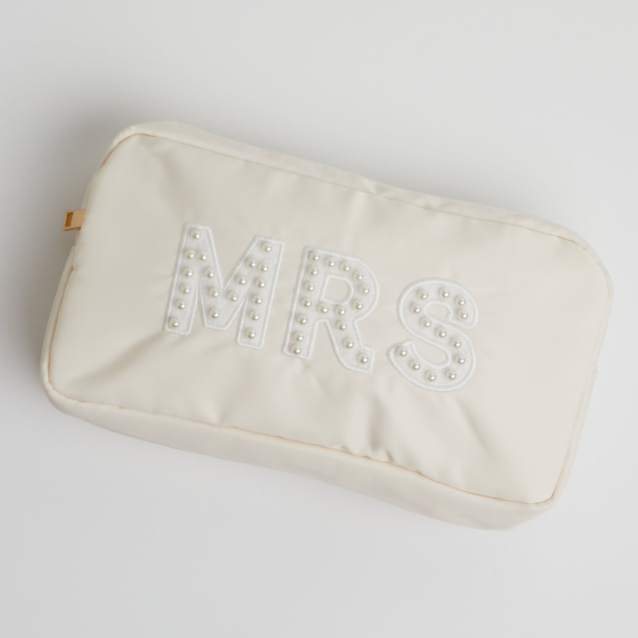 A pearl embroidered nude-colored MRS pouch on a white background