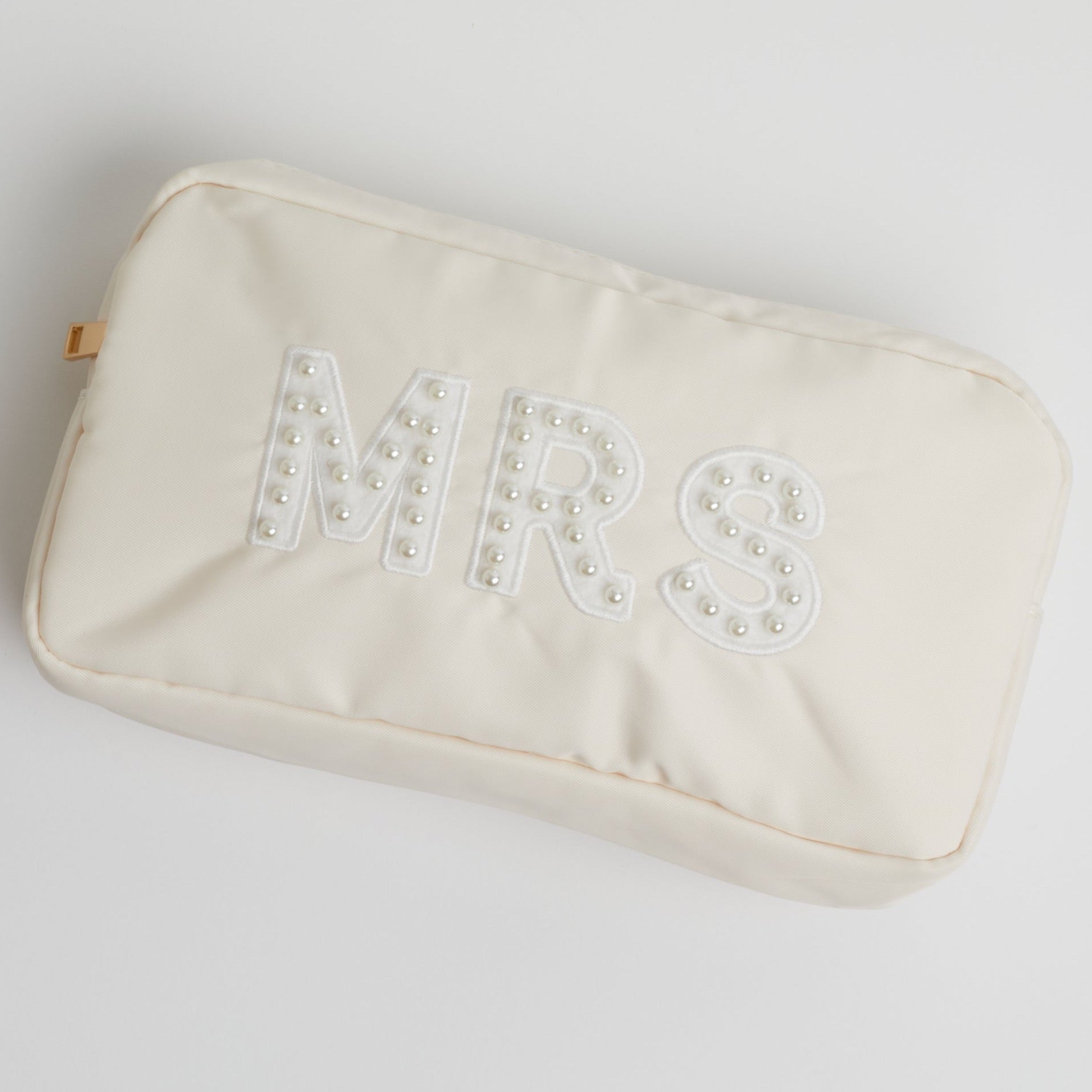 A pearl embroidered nude-colored MRS pouch on a white background