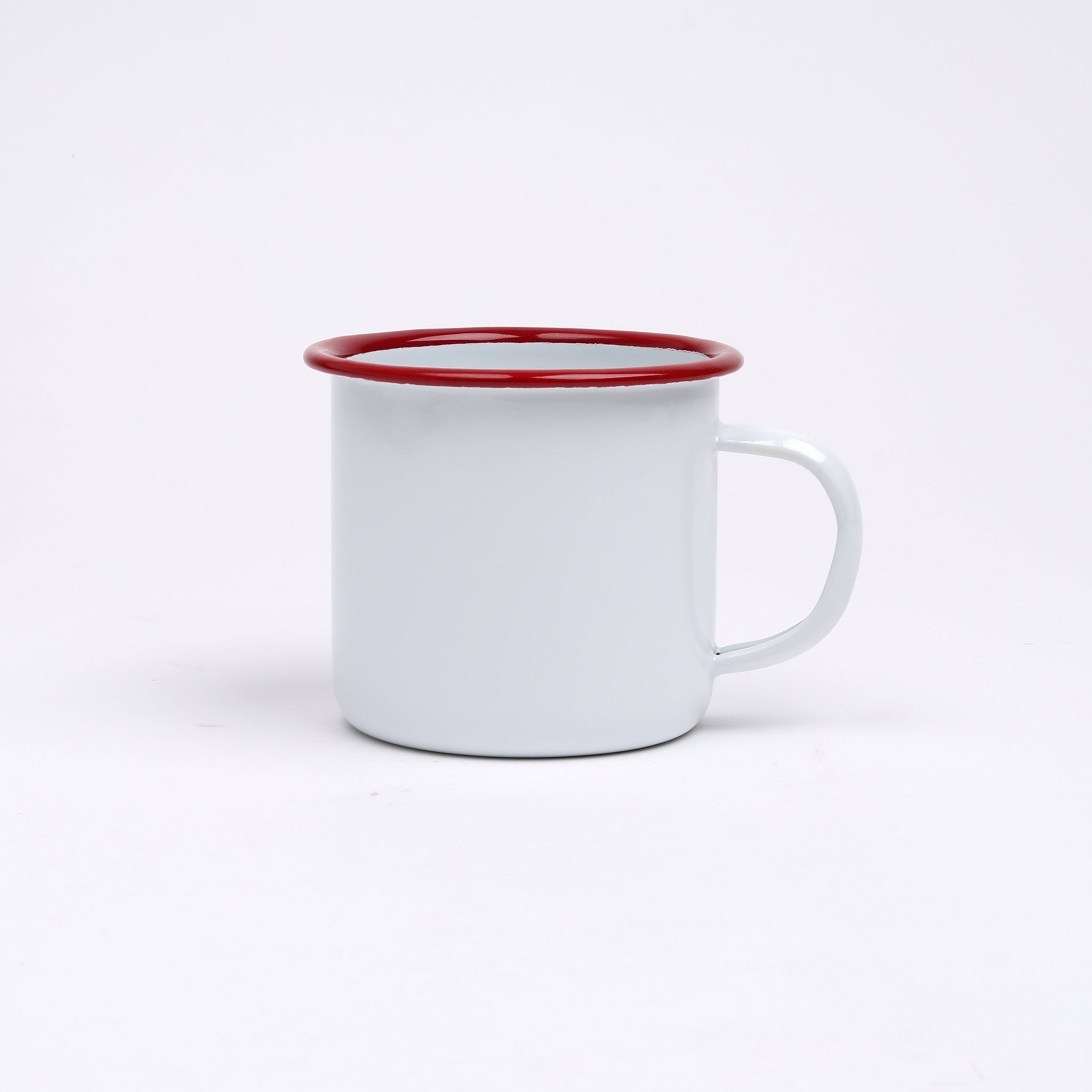 White mug with red rim on white background