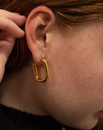 The Taryn Gold Rectangular Hoop Earrings on girl.
