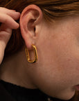 The Taryn Gold Rectangular Hoop Earrings on girl.
