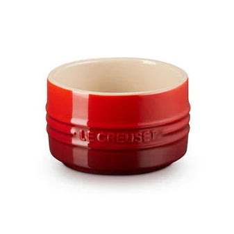 Red ceramic ramekin on a white background