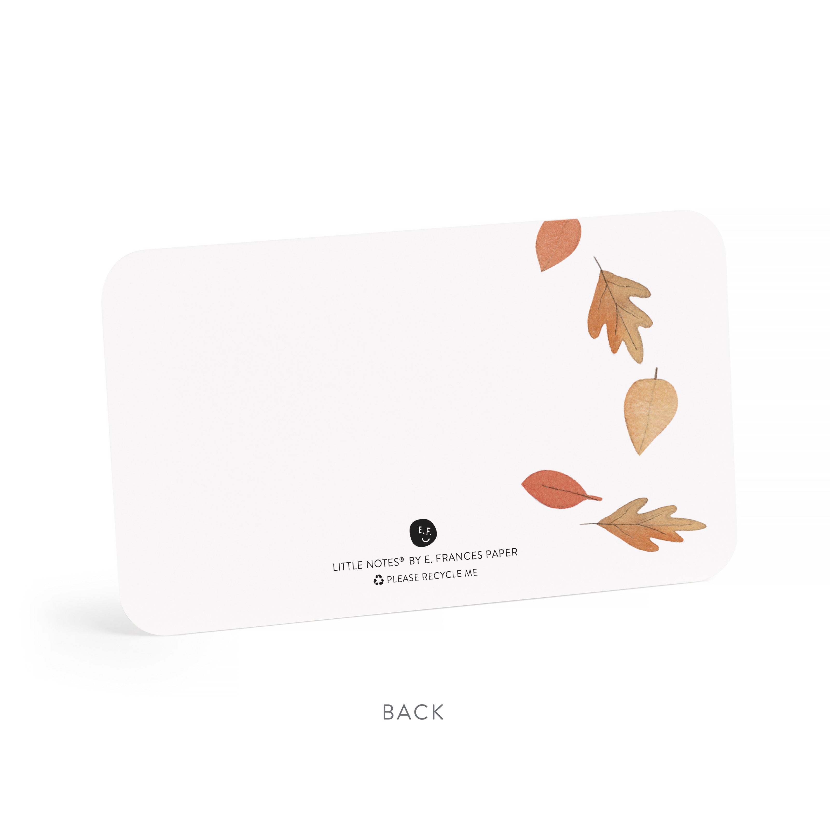 White notepad with autumn leaf design on a white background