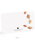 White notepad with autumn leaf design on a white background