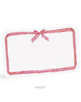 Rectangular white pillow with red stripes and a bow on a white background