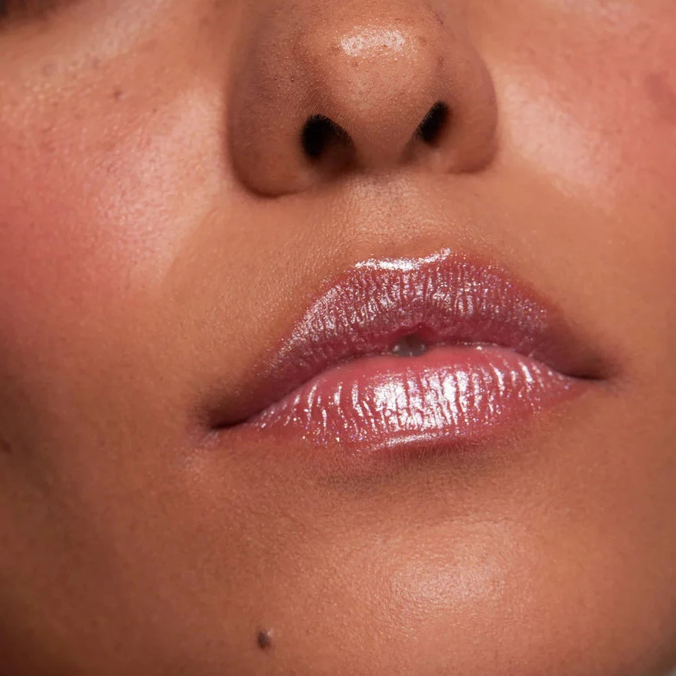 Girl wears Lust + Found Glossy Lip Lacquer in Billie on lips