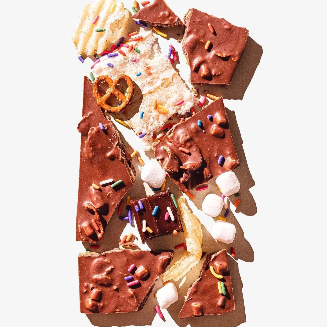 broke up chocolate bar with cake sprinkles marshmallow and chips throughout 