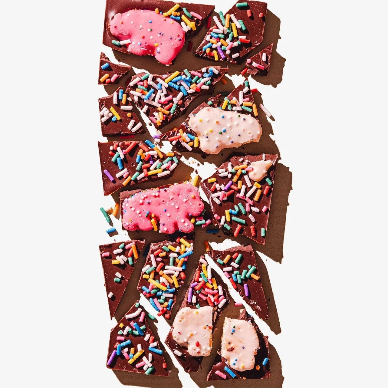 broken up chocolate bar with sprinkles and animal cookies throughout 