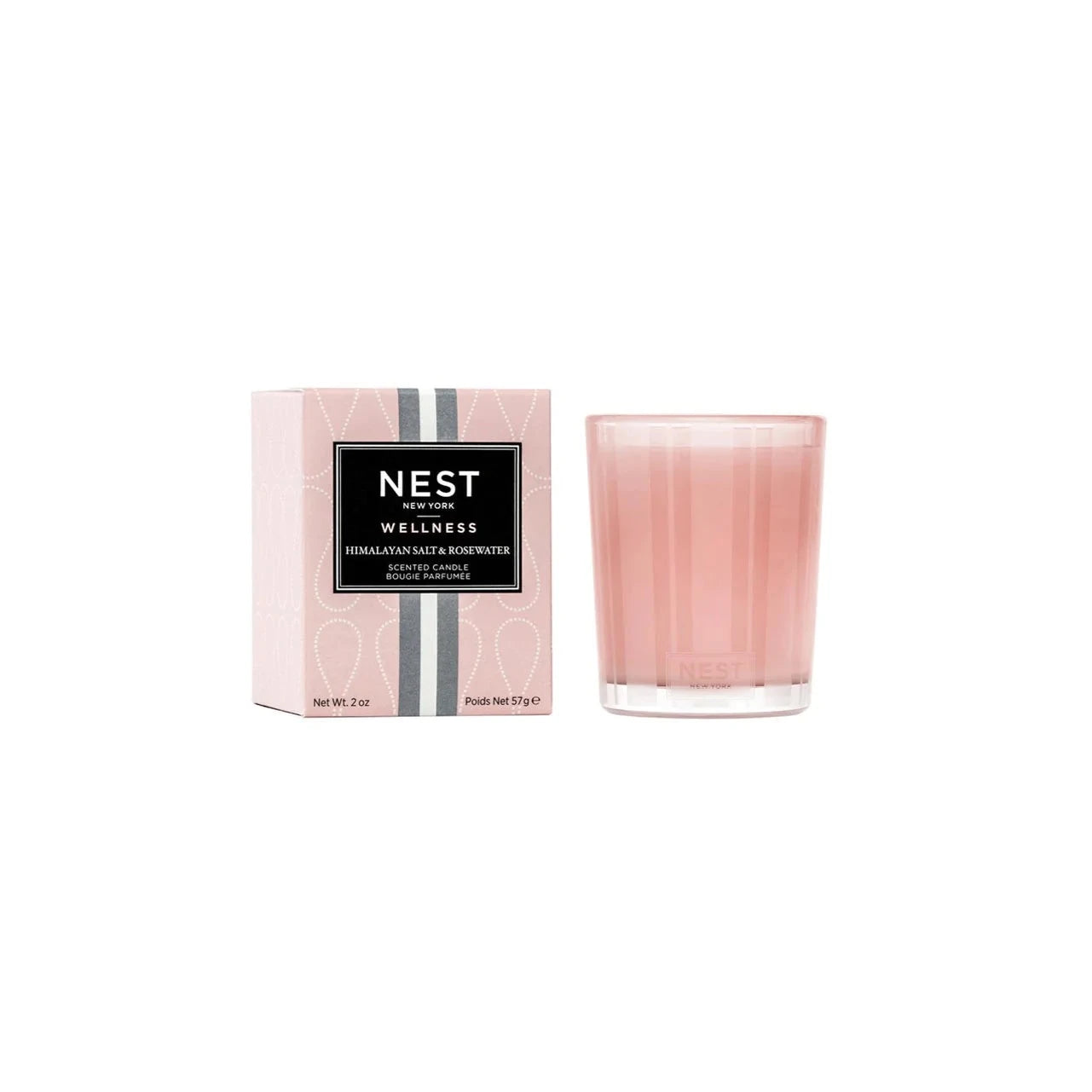 Pink-tinted wax housed in a glass vessel of the same color etched with elegant, frosted stripes.